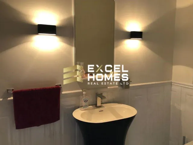 a bathroom with a mirror, sink, and toilet