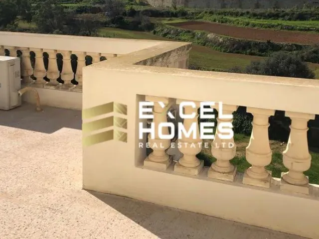 a wall with a bunch of windows and a fence