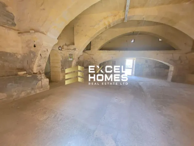 a tunnel with a large building with a clock on it 