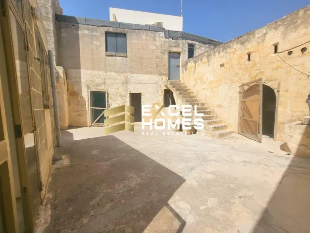 a building with a stone wall and a stone wall 