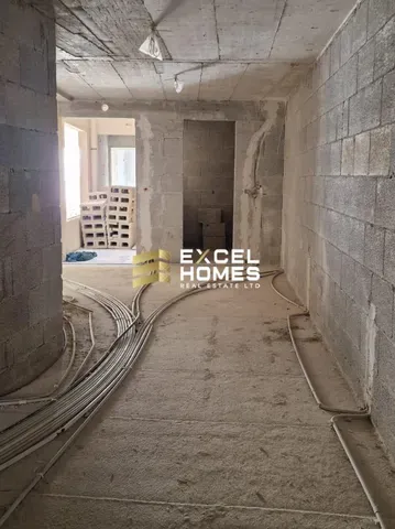 a building with a stone wall and a tunnel