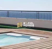 a pool with a blue sky and a blue fence