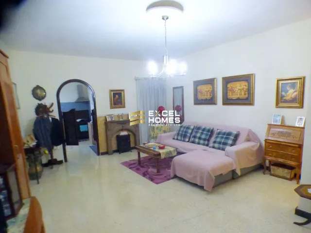 a living room with a couch, chair, and a mirror 