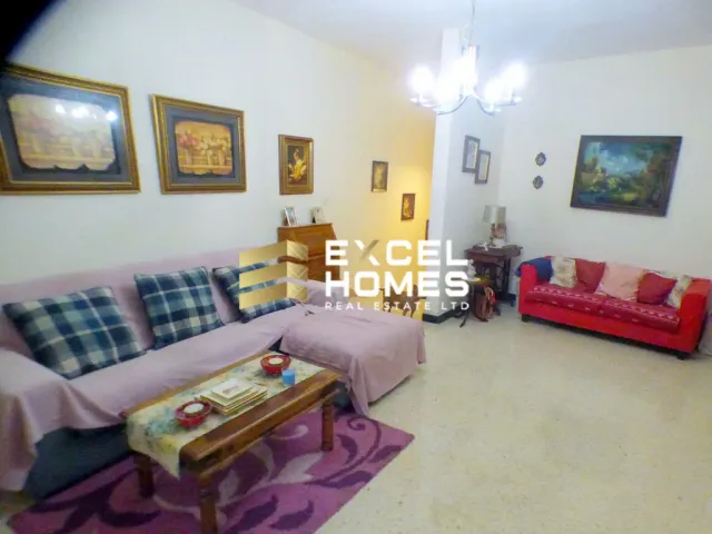 a living room with a couch, coffee table, and a television 