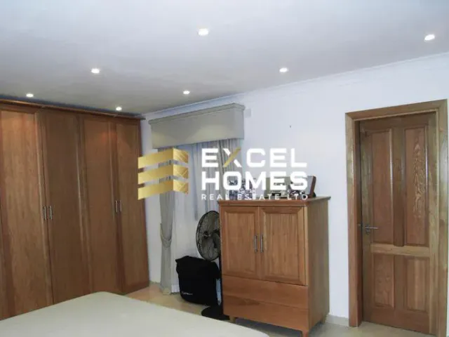 a room with a wooden floor and a black door