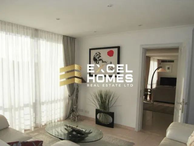 a living room with a couch, chair, and a window