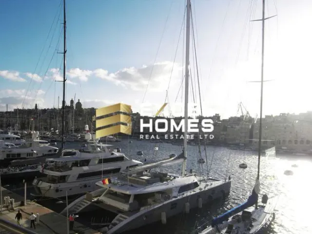 a harbor with boats docked and a lighthouse