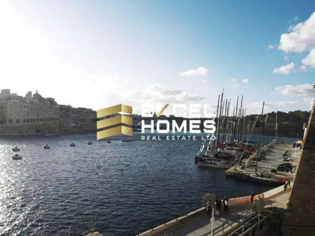 boats are docked at a dock in a harbor