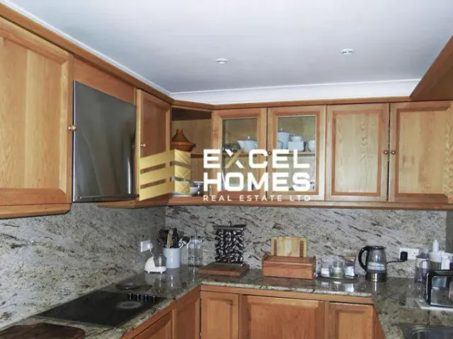 a kitchen with a sink, stove, and cabinets