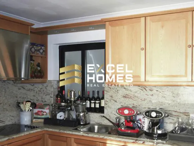 a kitchen with a stove, sink, and a microwave