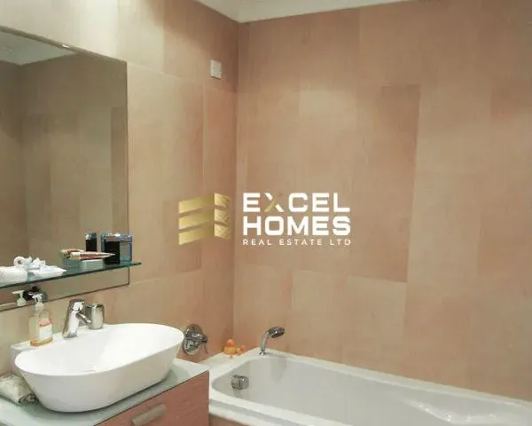 a bathroom with a large mirror and a bathtub