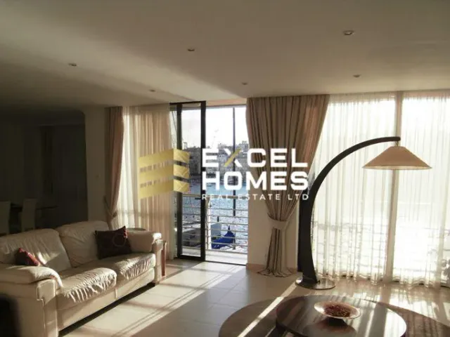 a living room with a couch, coffee table and a window