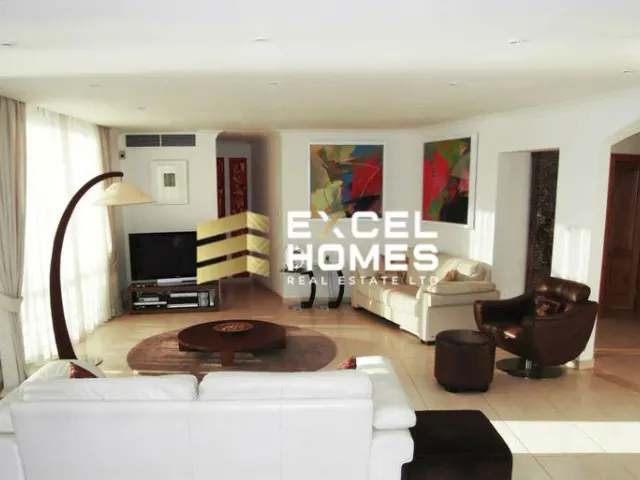 a living room with a couch, chair, and a rug