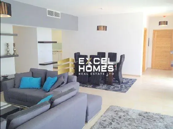 a living room with a couch, coffee table and a television