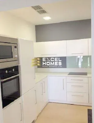 a kitchen with a clock and a microwave