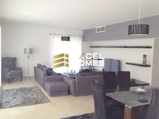 a living room with a couch, chair, and television