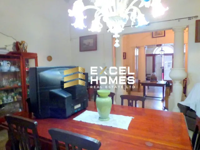 a small table with a drink and a television