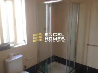 a bathroom with a shower stall and a toilet