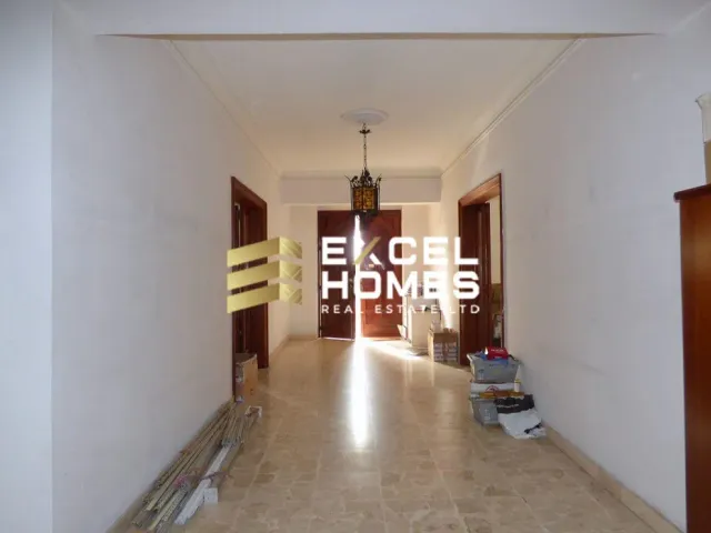 a hallway with a door and a door to a room