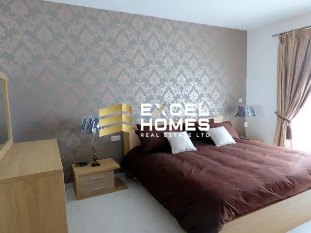 a bed with a white comforter and a white comforter 
