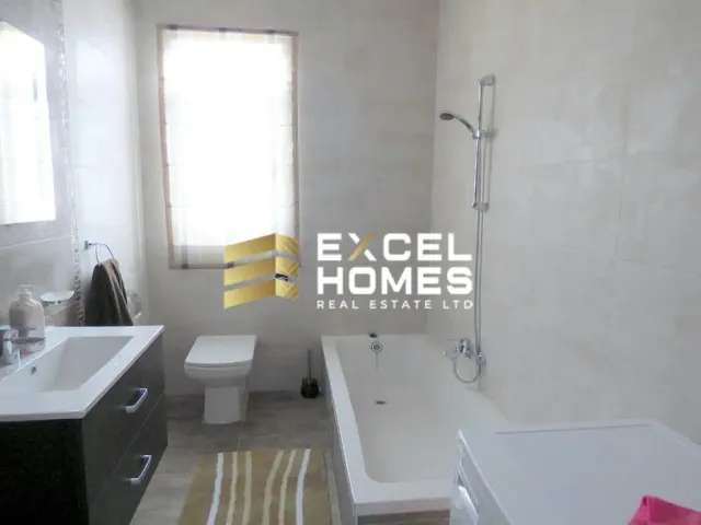 a bathroom with a sink, toilet, tub and window 