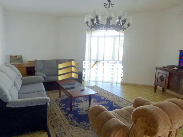 a living room with a couch, chair, and television