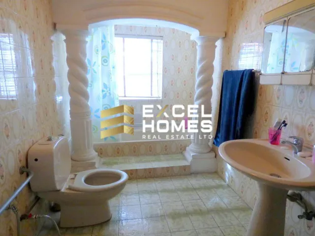 a bathroom with a toilet and sink in it