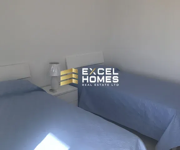 a bed with a white blanket and a white bedspread