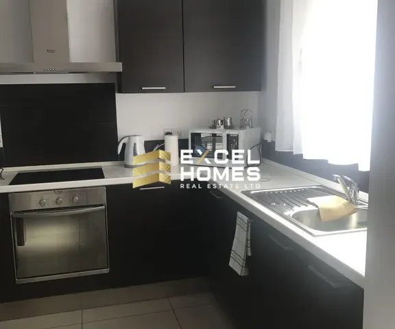 a kitchen with a sink, stove, and a microwave