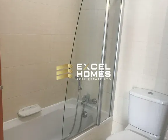 a bathroom with a shower stall and a toilet