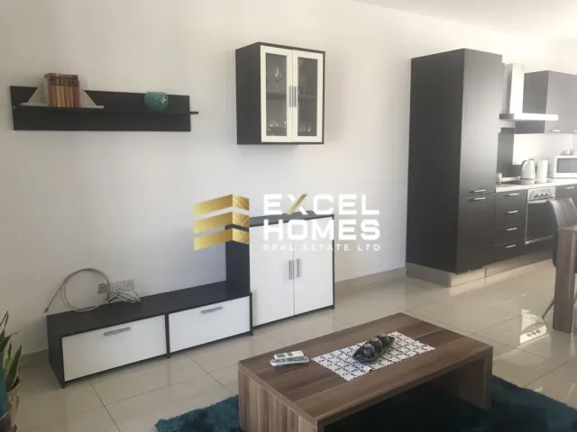 a kitchen with a television and a refrigerator