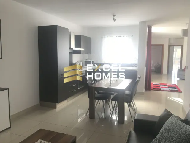 a kitchen with a table, chairs, and a refrigerator