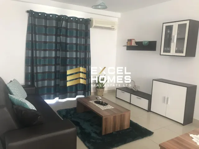 a living room with a couch, chair, and a television