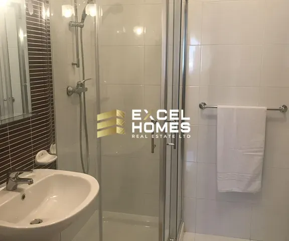 a bathroom with a shower, sink, and toilet