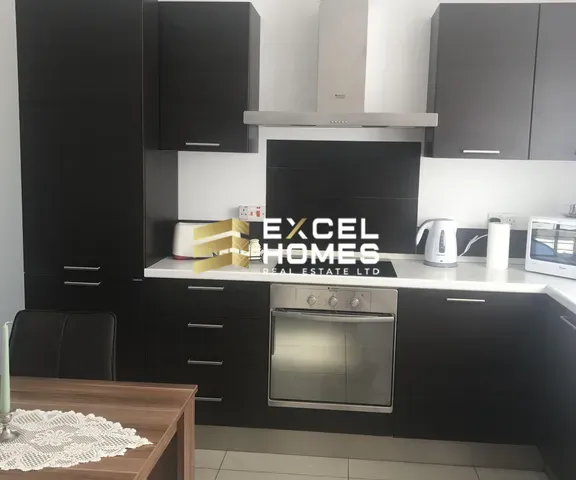 a kitchen with a stove, microwave, and refrigerator