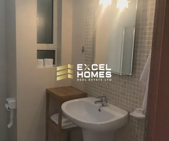 a bathroom with a sink, mirror, and toilet