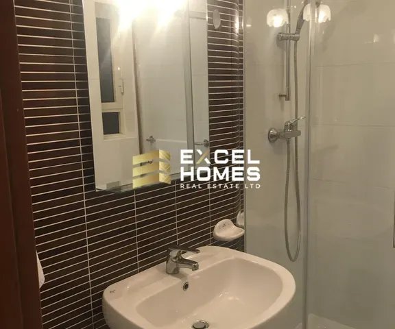 a bathroom with a sink, mirror and toilet