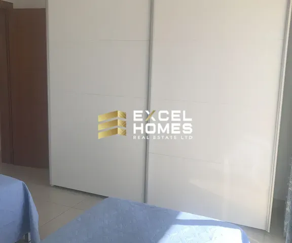 a door is open to a room with a refrigerator