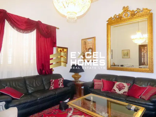 a living room with a couch, coffee table and a lamp 