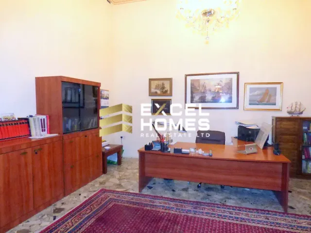 a living room with a couch, chair, and television 
