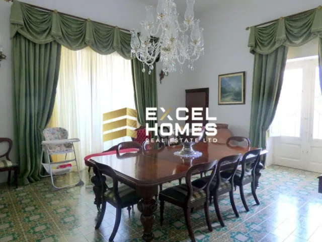 a dining room table with a large window 