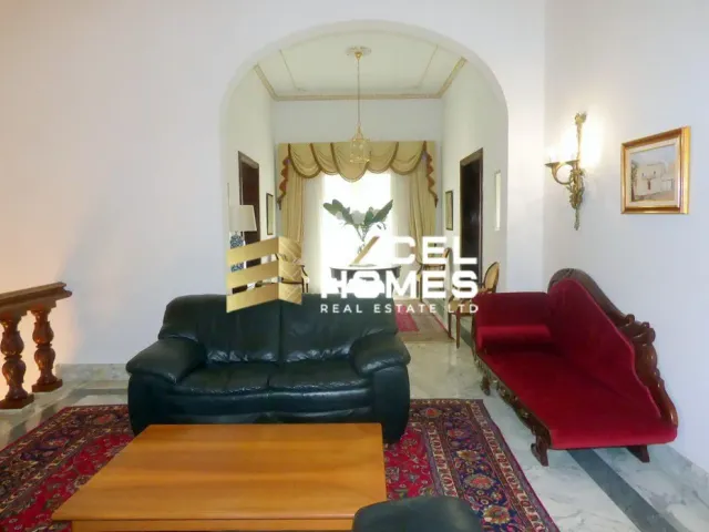 a living room with a couch, chair, and a rug 