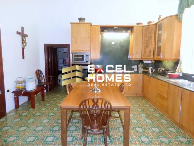 a kitchen with a table and a refrigerator 