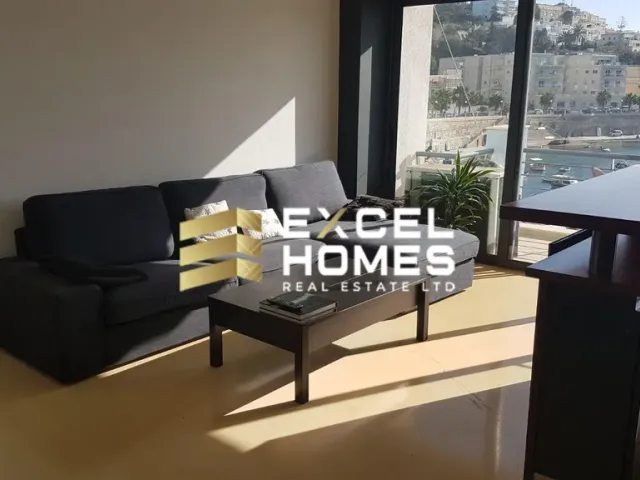 a living room with a couch, coffee table and a television 