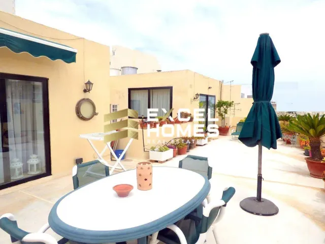 a table with chairs and a table cloth