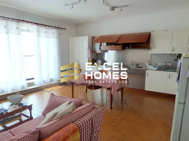 a kitchen with a refrigerator, stove, sink and a table