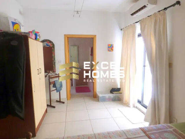 a room with a bed, a desk, and a window