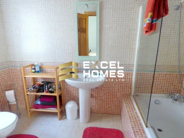 a bathroom with a shower, sink, and toilet