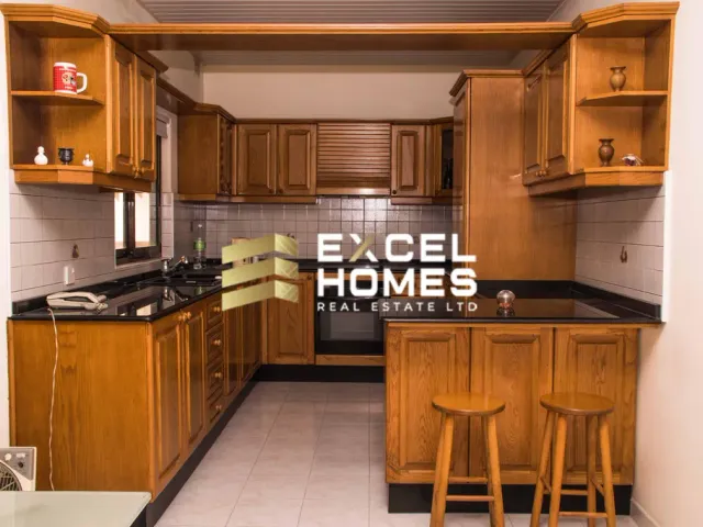 a kitchen with a stove, sink, cabinets and a refrigerator