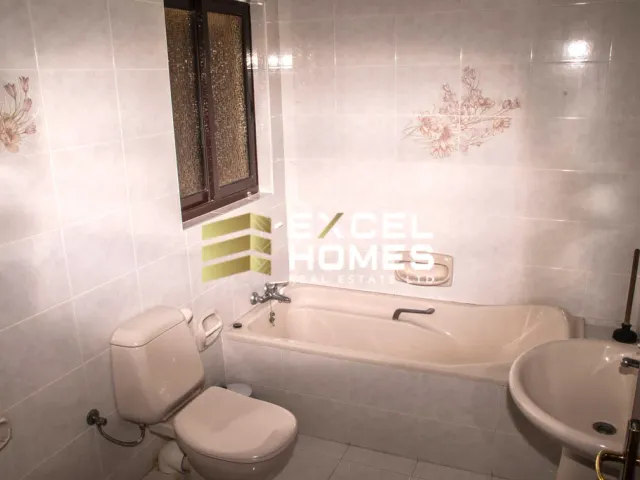 a bathroom with a toilet, sink, and bathtub